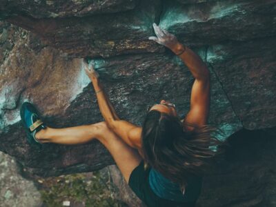 photo of woman climbing mountain